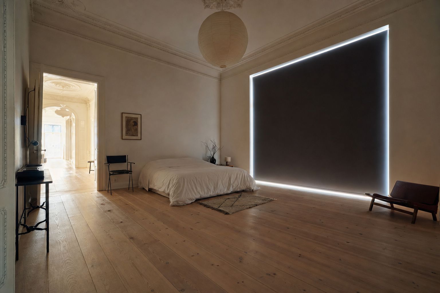 A bright bedroom in the afternoon with a blackout roller fully lowered over the window, the room calm and dim while a hard line of daylight escapes around all four edges of the blind