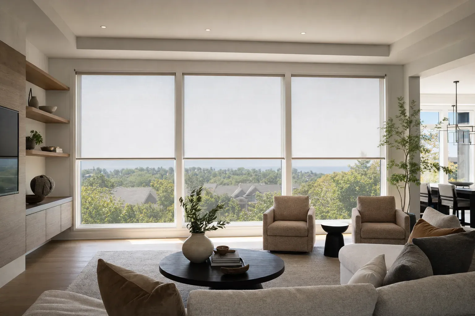 Three separate pale motorized roller shades lowered to one shared line across a wide Vaughan great-room wall